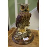 A MODEL OWL ON WOODEN PLINTH BASE