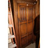 A WELL MADE REPRODUCTION OAK FINISHED TWO DOOR WARDROBE with full width hanging rail and hat shelf