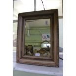 A STRIPPED FRAMED RECTANGULAR BEVELLED PLATE WALL MIRROR