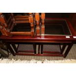 A MAHOGANY AND GLAZED INSERT RECTANGULAR COFFEE TABLE with twin orphans below