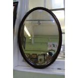 A FANCY FRAMED OVAL BEVEL PLATE WALL MIRROR