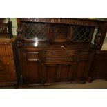 A 20TH CENTURY REPRODUCTION OAK FINISHED COURT STYLE CUPBOARD, with diamond leaded panels, the