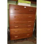 A RETRO DESIGNED TEAK CHEST OF SIX DRAWERS supported on turned tapering legs