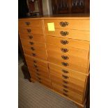 A MODERN LIGHT OAK FINISHED MULTI DRAWER SIDE-BY-SIDE CHEST, bearing the makers label, John Austin