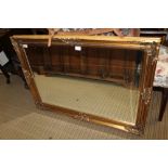 A LARGE FANCY GILT FRAMED RECTANGULAR BEVELLED PLATE WALL MIRROR