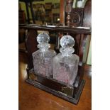 A REPRODUCTION MAHOGANY CASED TWIN BOTTLE TANTALUS with stoppers