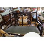 A 20TH CENTURY STAINED BEECHWOOD FRAMED TWO PERSON SETTLE, with upholstered seat pad