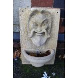 A CAST MASK HEAD WALL MOUNTING WATER FEATURE