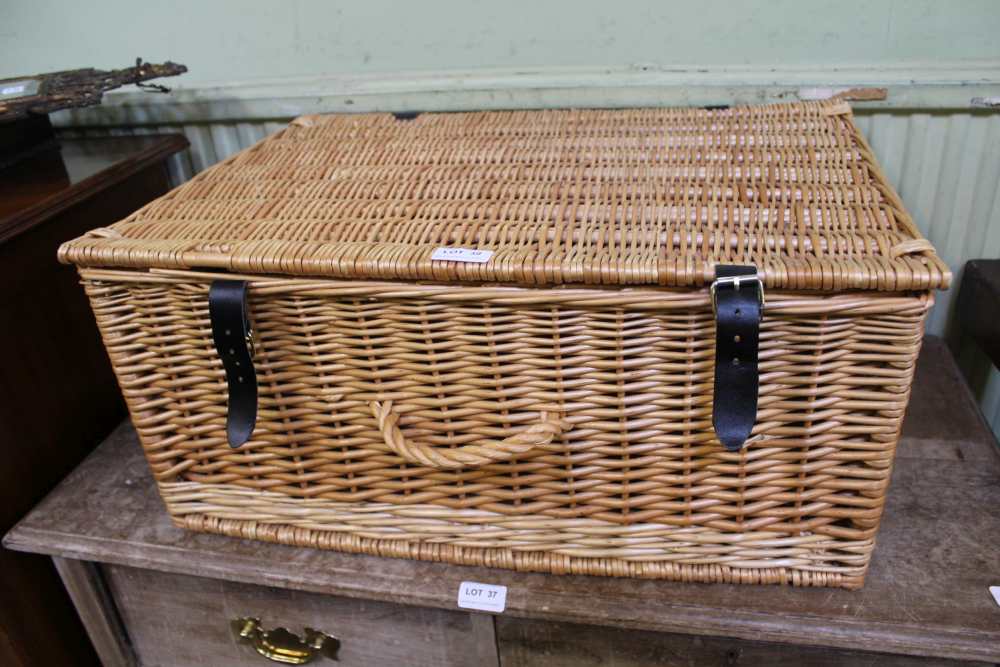 A WOVEN WICKER BASKET CONTAINING A WOVEN WICKER TRAY