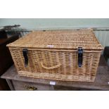 A WOVEN WICKER BASKET CONTAINING A WOVEN WICKER TRAY