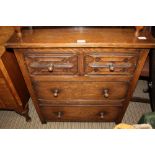A REPRODUCTION OAK CHEST OF FOUR DRAWERS