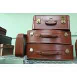 A GOOD SELECTION OF TANNED SUITCASES VARIOUS