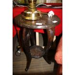 AN ORIENTAL CARVED WOODEN FLOWER HEAD DESIGN CIRCULAR TOPPED OCCASIONAL TABLE on three shaped