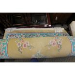 A MUSTARD GROUND CHINESE WASHED WOOL FLOOR CARPET with floral guard border