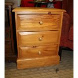 A MODERN PINE BEDSIDE CHEST OF THREE DRAWERS
