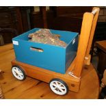 A WOODEN CHILD'S PUSH ALONG TROLLEY with blocks