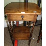 AN OAK SIDE TABLE fitted with a single drawer, on barley twist and block legs, united by an