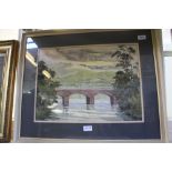 A WATERCOLOUR STUDY OF A BRICK BRIDGE OVER A VALLEY RIVER, indistinctly signed, double mounted, in