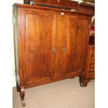 A MADE-UP OAK SCHOOL TYPE TWO DOOR CUPBOARD, having pine shelved interior supported on fancy