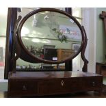 A 19TH CENTURY MAHOGANY FINISHED OVAL PLAIN PLATE DRESSING TABLE TOP MIRROR, on large three drawer