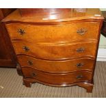 A REPRODUCTION SERPENTINE FRONTED FOUR DRAWER CHEST, on plain bracket feet