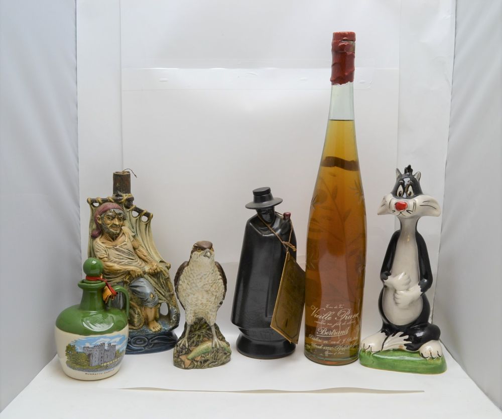 A SELECTION OF NOVELTY CERAMIC DECANTERS, some with contents (viewing recommended); Warner Bros. "