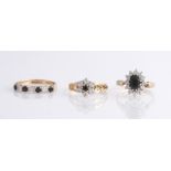 Three hallmarked 9ct yellow gold rings with sapphires and cubic zirconia stones in various