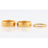Three hallmarked 22ct yellow gold wedding bands, two Victorian examples and one early 20th Century