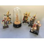 Five figurine groups, with glass domed carved cork pagoda.