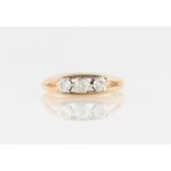 A three stone diamond ring, set with three graduated round brilliant cut diamonds, total diamond