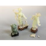 Three jade figurines on wooden bases, depicting buddha, female warrior and female with fan. (One