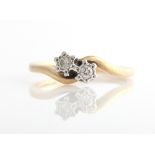 A hallmarked 9ct yellow gold, two stone diamond ring, set with two round, brilliant cut diamonds