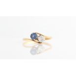 A two stone sapphire and colourless paste ring, stamped 18ct, ring size L.
