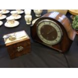 A tea caddy and mantel clock.
