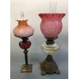 Two oil lamps with glass shades.