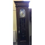A Cambridge Clock Company oak cased grandfather clock with three brass weights and brass pendulum.