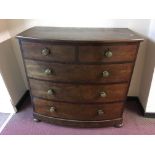 A mahogany bow front five drawer chest on bun feet.