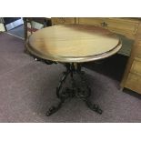 A mahogany topped cast iron base pub table.