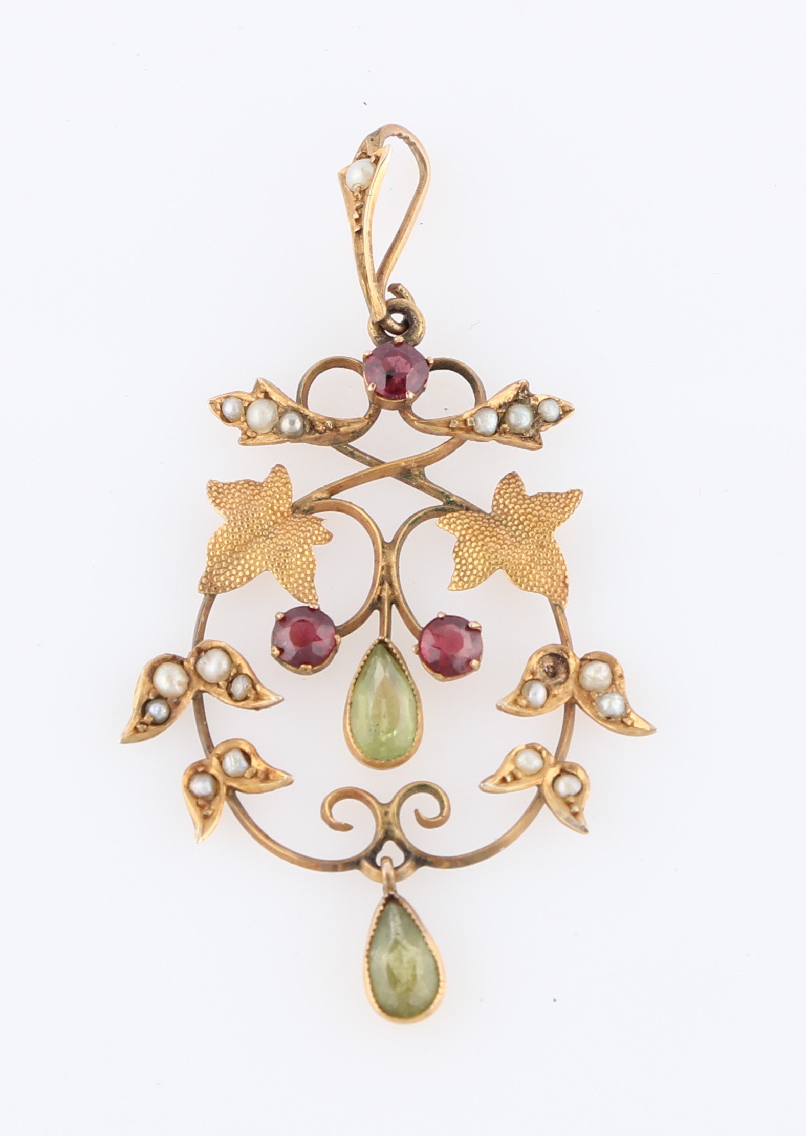 An Edwardian peridot, green glass, seed pearl and garnet pendant, set with round cut garnets, a pear