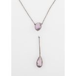 An amethyst necklet, featuring an oval cut amethyst suspending a pear cut amethyst, in unmarked