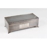 A silver cigarette box, of rectangular form featuring repeat engraved design to lid and body,