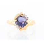 A hallmarked 14ct yellow gold iolite and diamond dress ring, set with a cushion cut iolite,