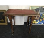 A small oak Gothic style table on turned and fluted legs.