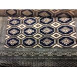 A large blue and cream border pattern rug.