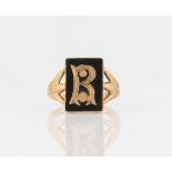A memorial ring, set with a rectangular piece of black hardstone, surmounted with the initial R,