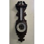 A porcelain faced mercury filled oak cased barometer.