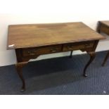 A mahogany reproduction two drawer desk.