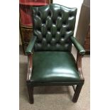 A leather button back office chair with two dining chairs.
