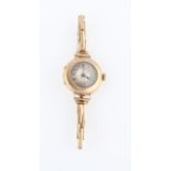 A 9ct yellow gold ladies wrist watch, having hourly Arabic numeral markers with minute track border,