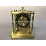 A brass and glass cased Schatz mantel clock. Height 21cm.